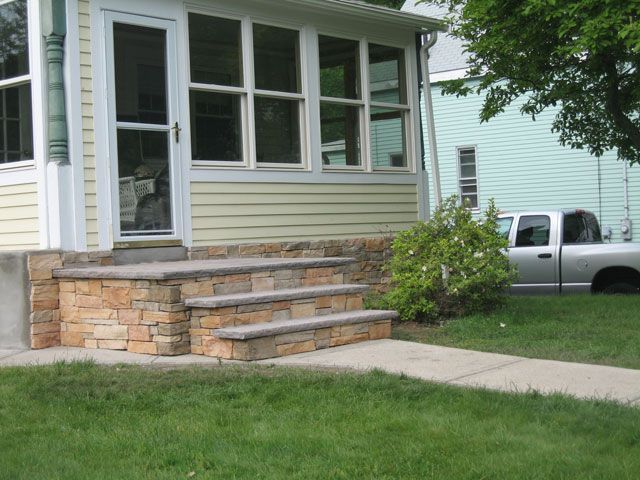 A white truck is parked in front of a house