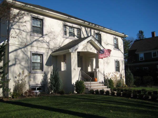 A white house with an american flag in front of it