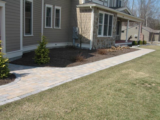 A house with a walkway leading to the front door