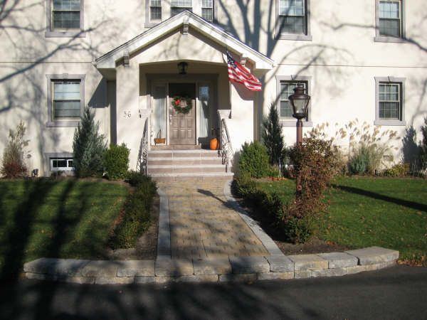 A white house with a flag on the porch