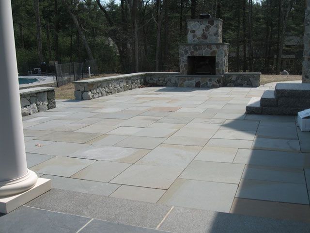 A patio with a fireplace in the middle of it