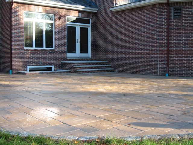 A brick house with a patio in front of it