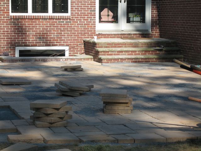 A brick house with a patio in front of it