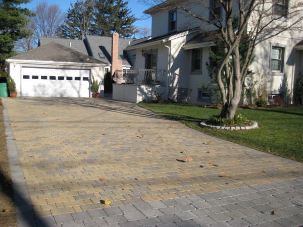 A driveway leading to a house with a garage