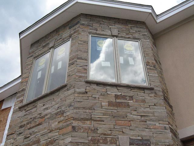 A house with a stone facade and a few windows