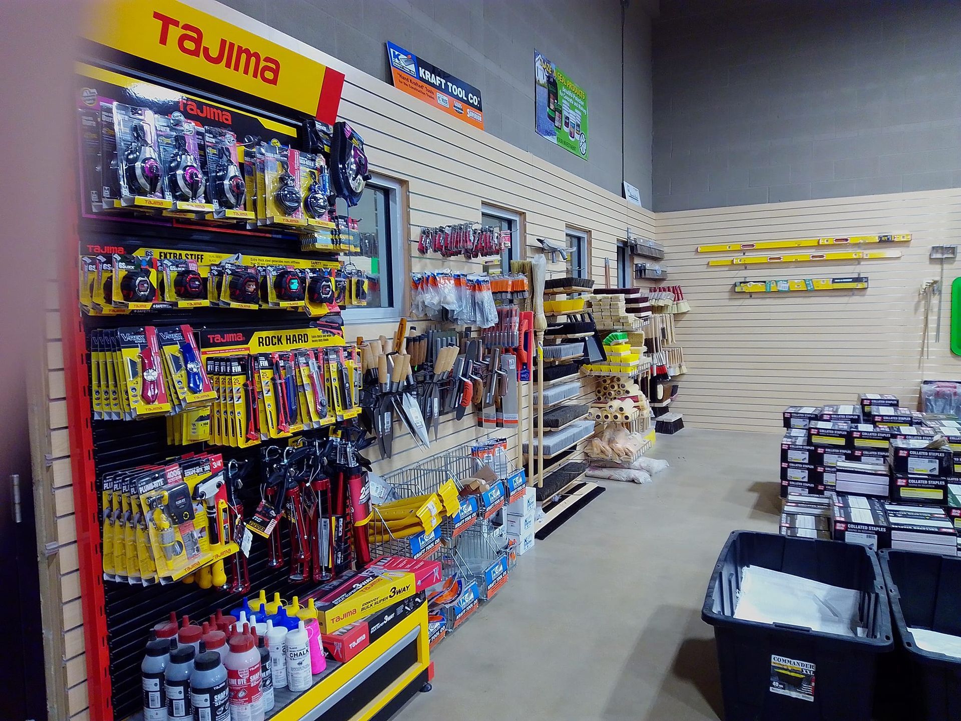Hardware store aisle with tools and supplies on display.