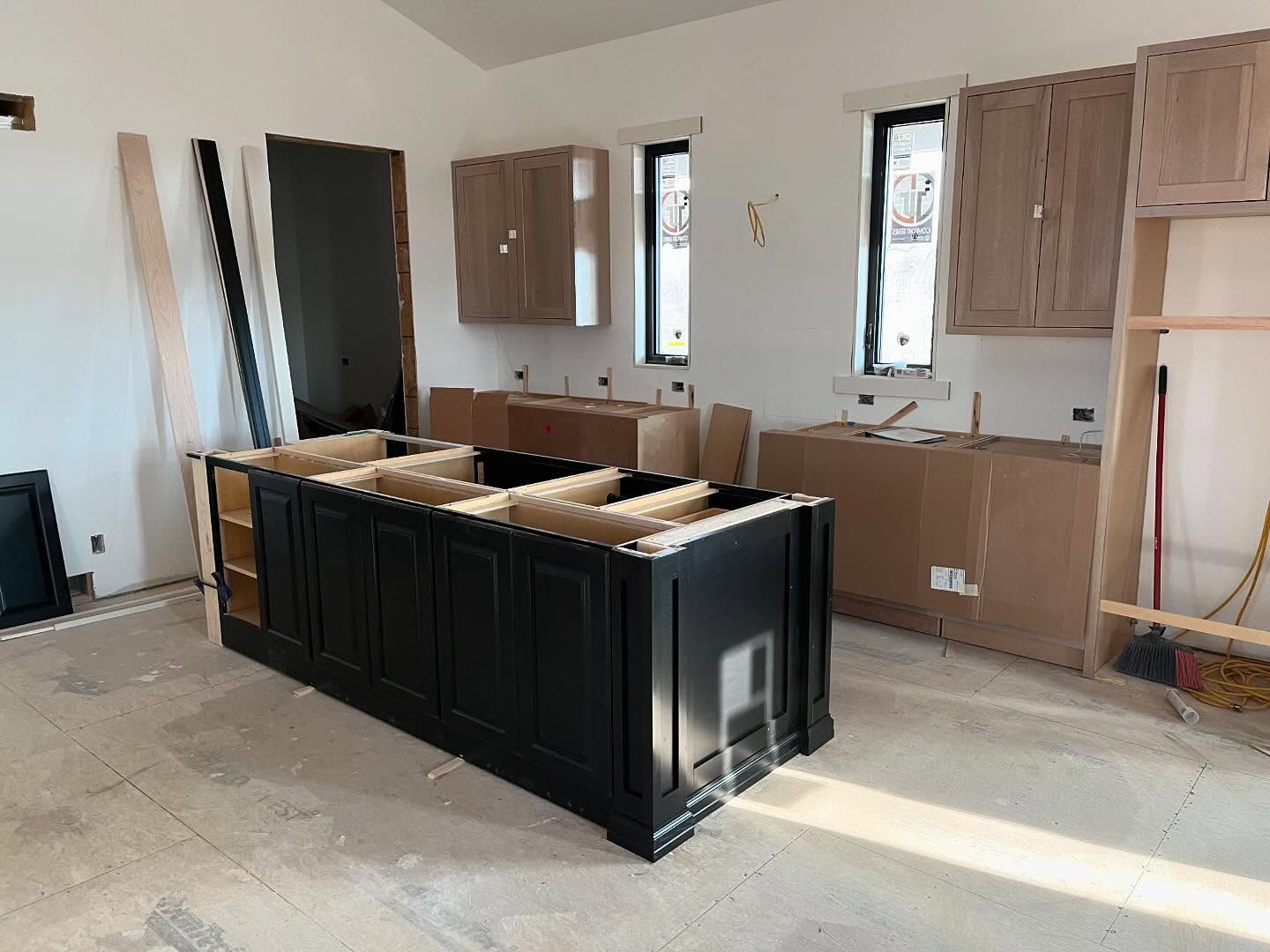 A kitchen under construction with a large island in the middle of the room.
