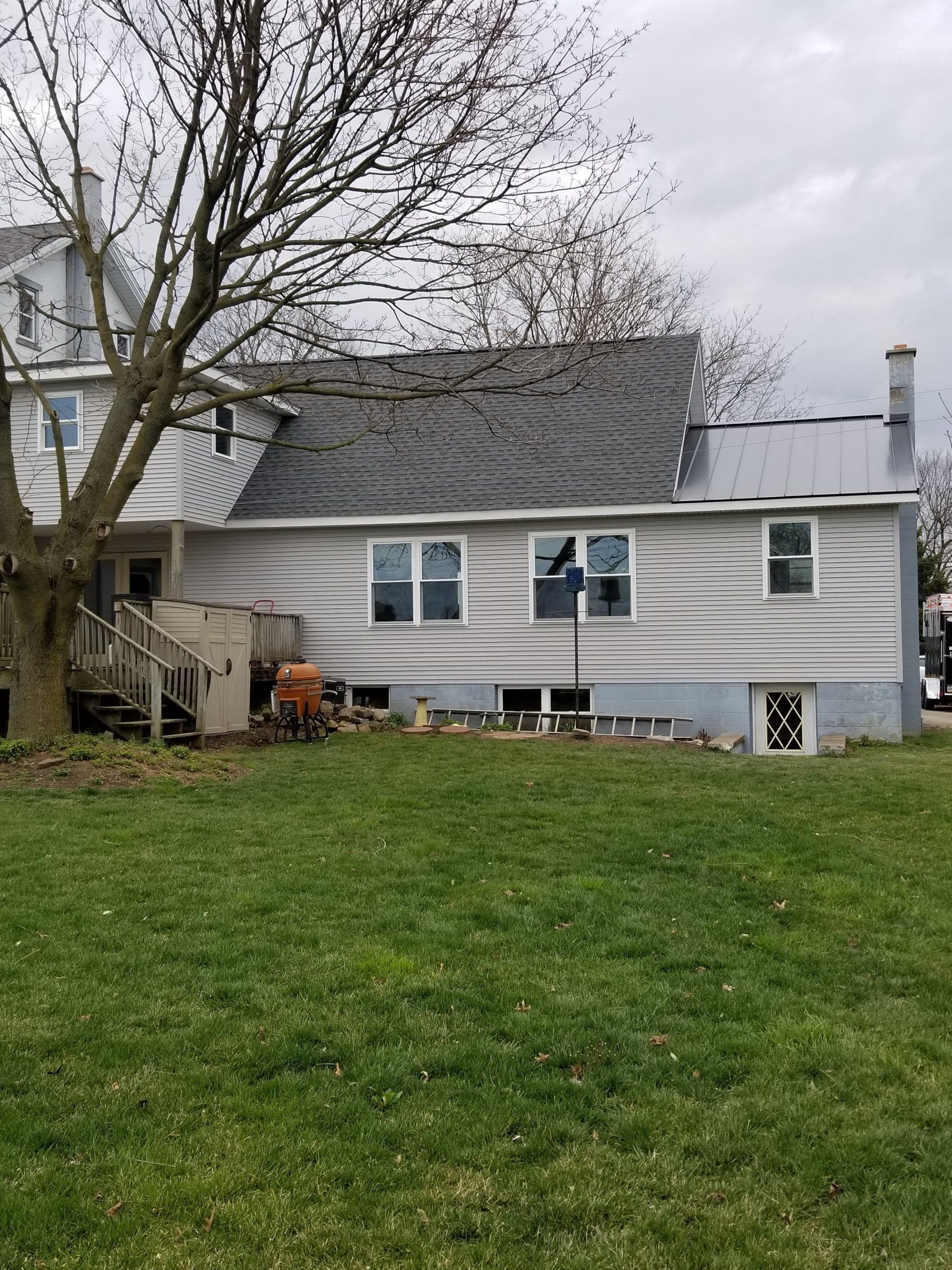 Residential house with shingle and metal roof