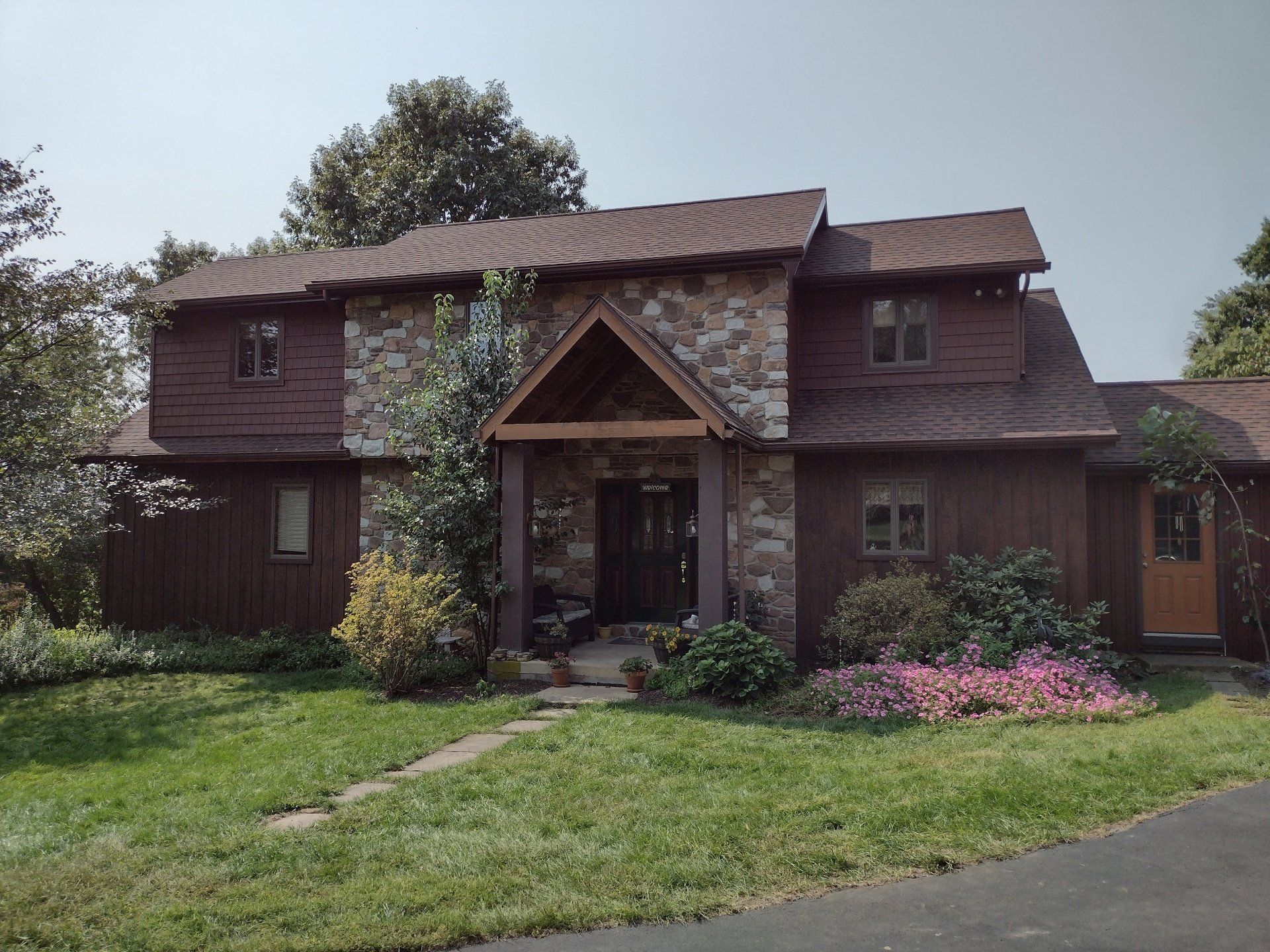 Board siding and asphalt roofing