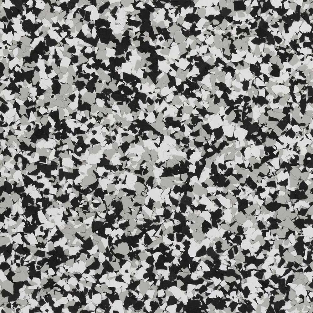 Speckled flooring with patches of black, gray, and white.