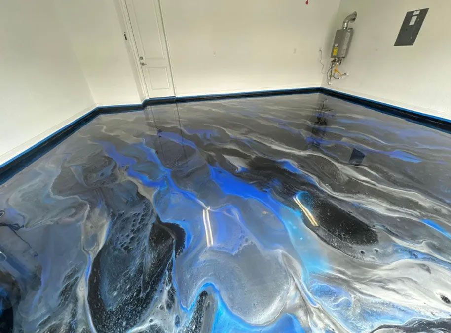 Epoxy garage floor with blue, silver, and black swirling colors.