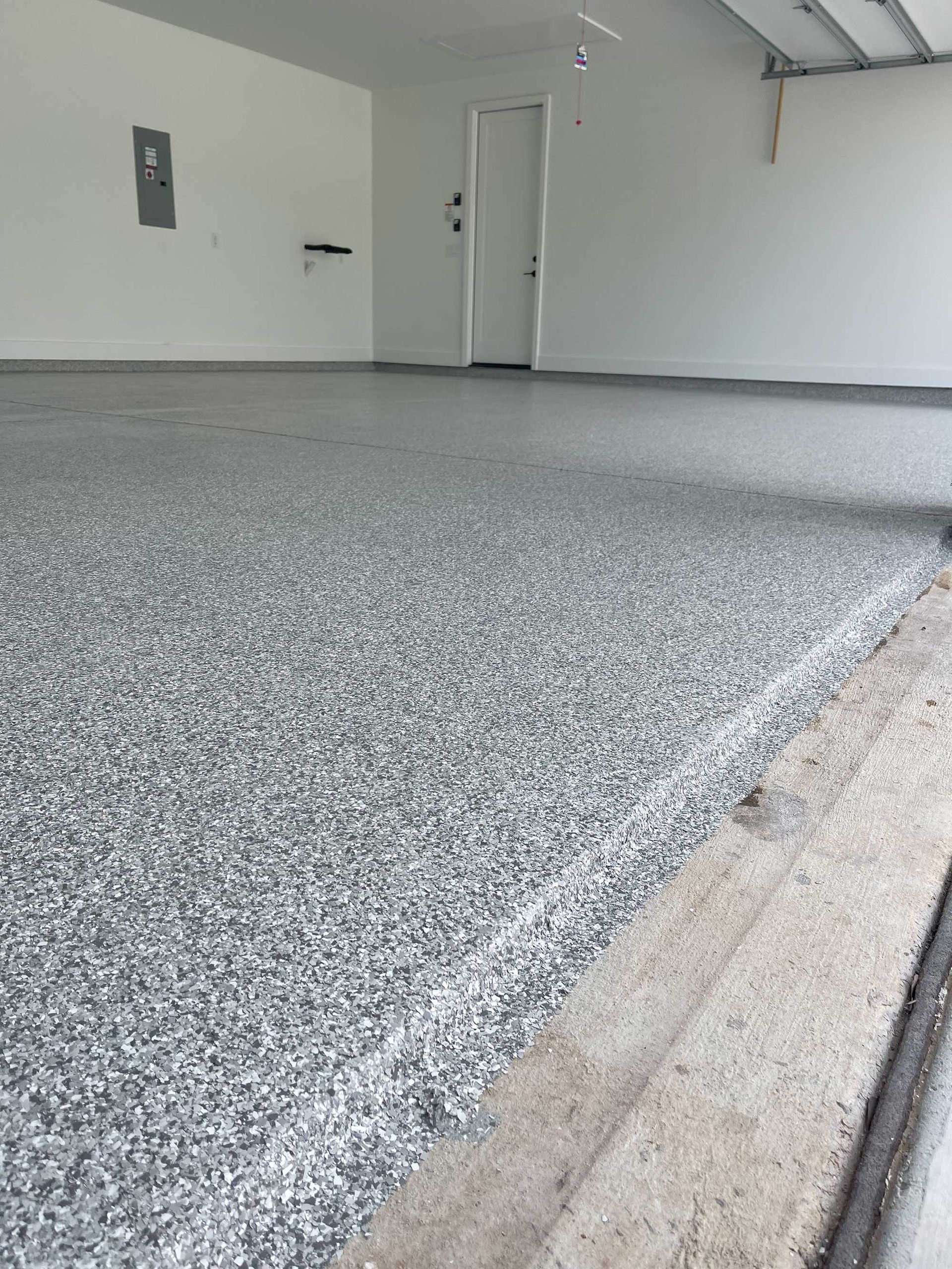 Gray epoxy-coated garage floor with a neutral color palette.