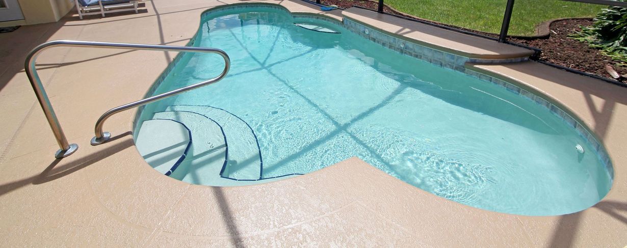 Empty garage with epoxy floor, white walls, window, and garage door partially open.