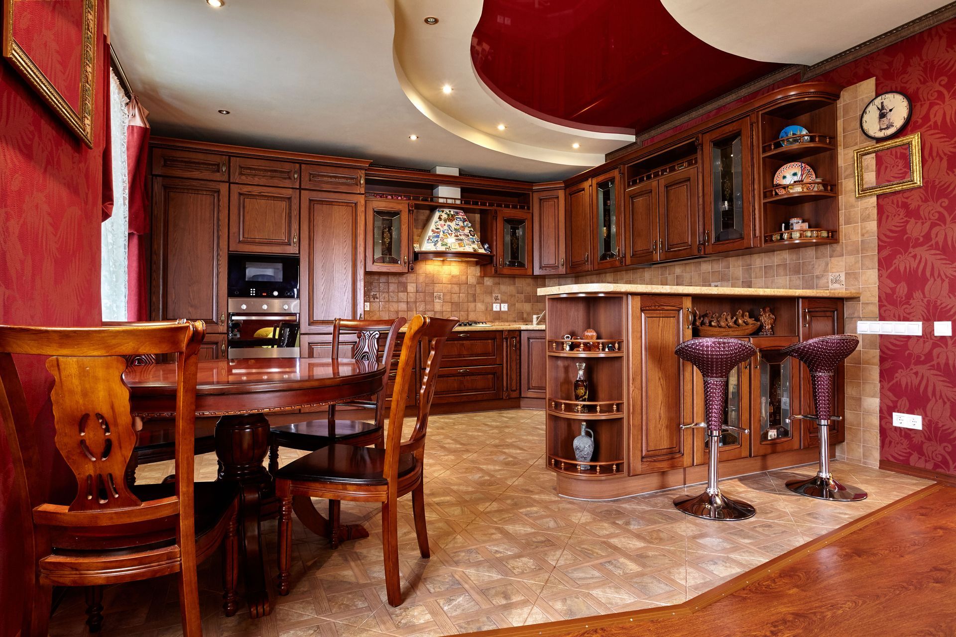 Luxurious home bar and kitchen with dark wood cabinetry, red walls, and marble flooring