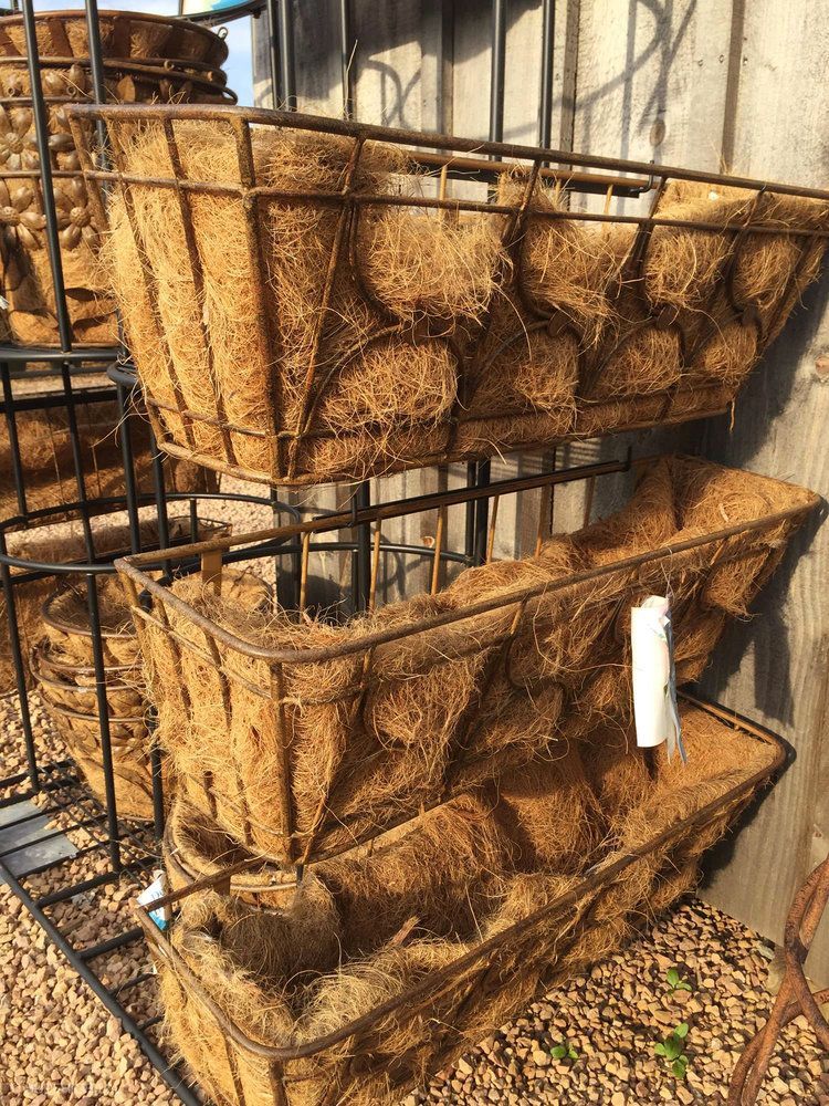 A bunch of baskets made of coconut fiber are stacked on top of each other.