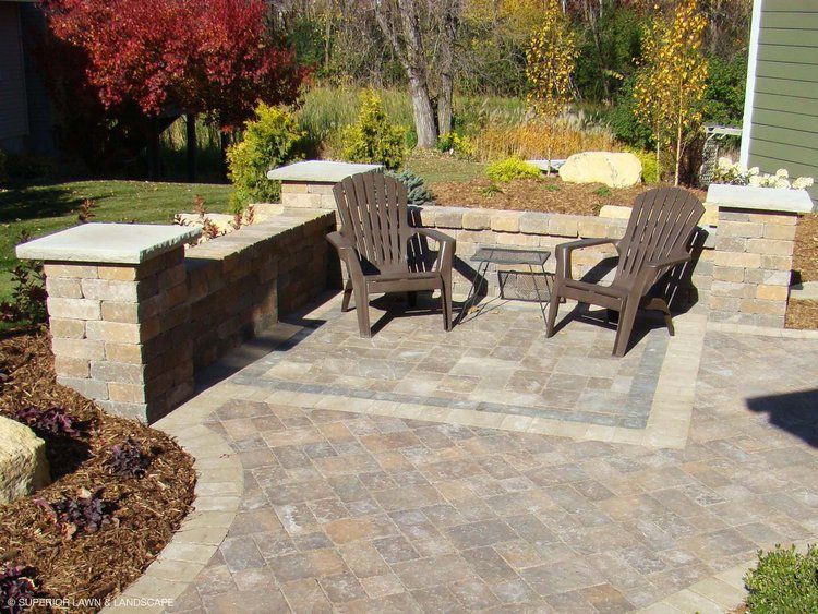 A patio with two chairs and a table on it