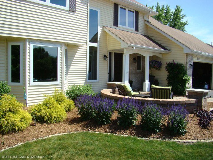 A house with a porch and a patio in front of it