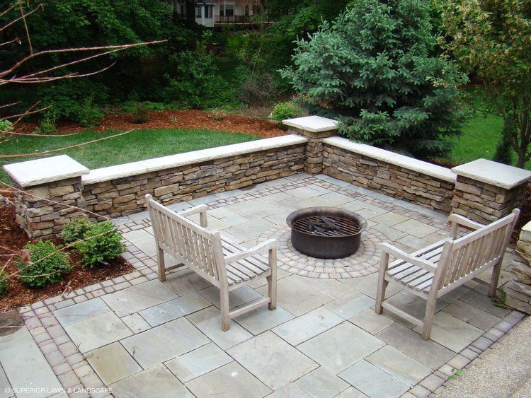 There is a fire pit in the middle of the patio.