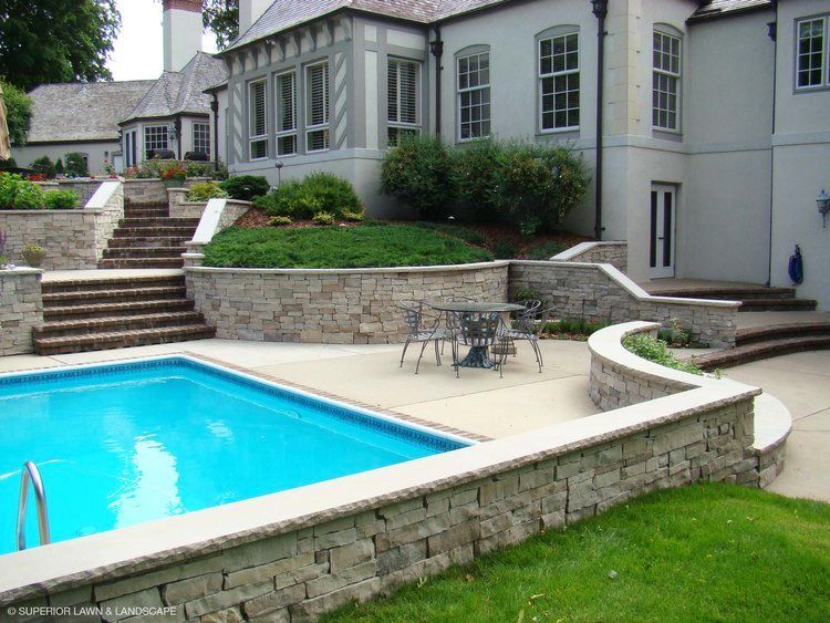 A large house with a swimming pool in front of it