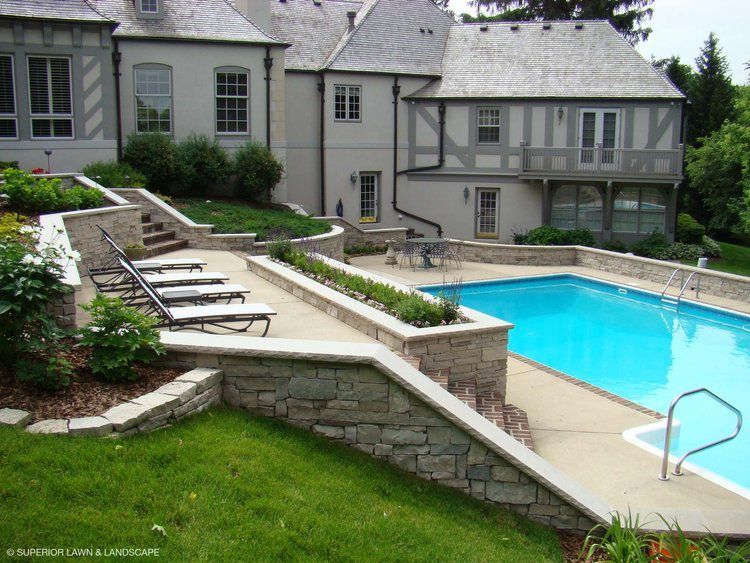 A large house with a large swimming pool in front of it