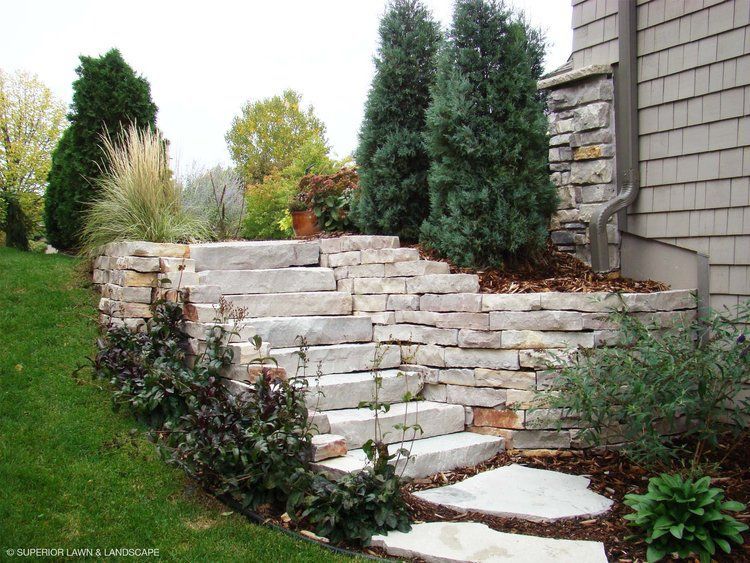 A stone wall with stairs leading up to it