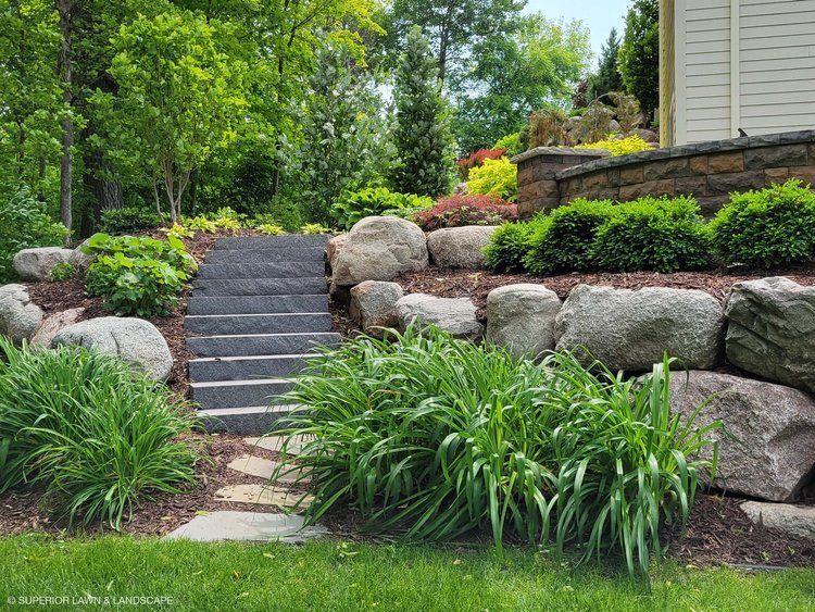 There are stairs leading up to a house in the backyard.