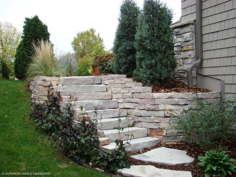 A stone wall with stairs leading up to it