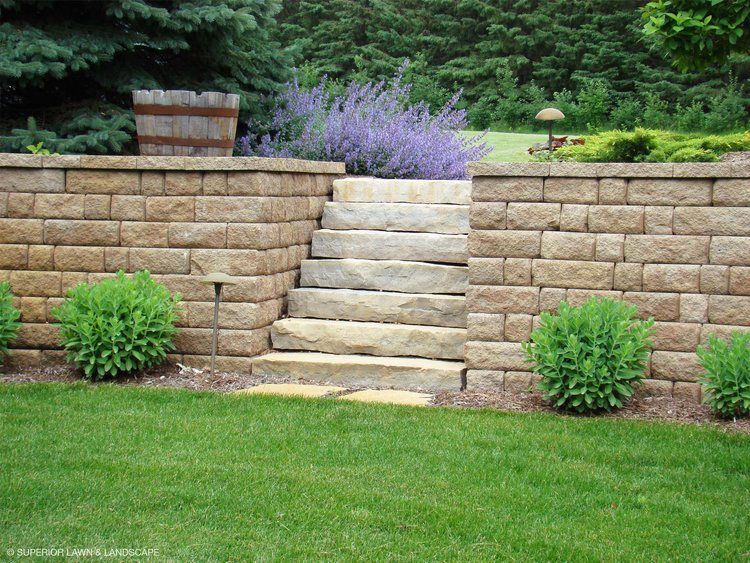 A stone wall with stairs leading up to it