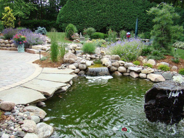 A pond with a waterfall in the middle of it