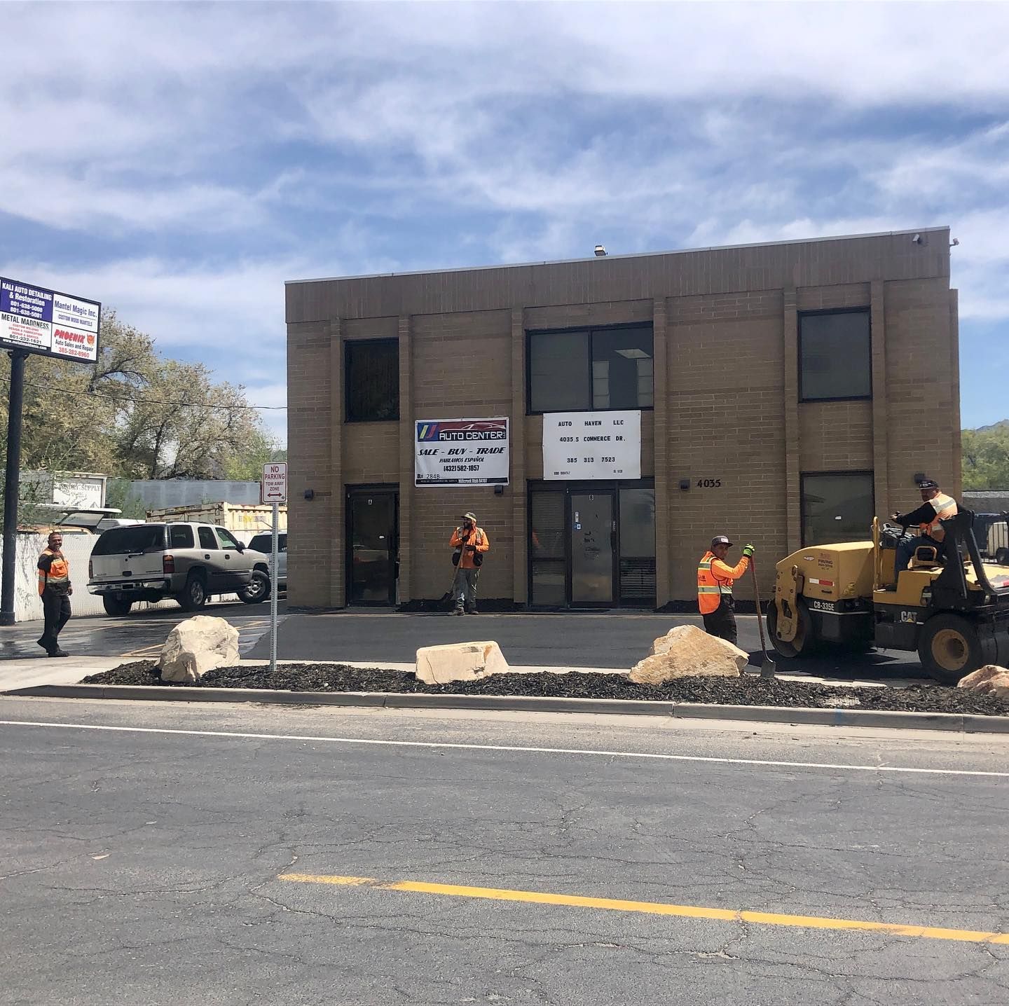 a couple of construction vehicles are driving down a road