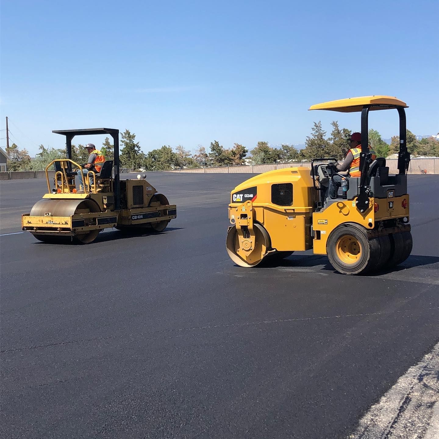 a couple of construction vehicles are driving down a road