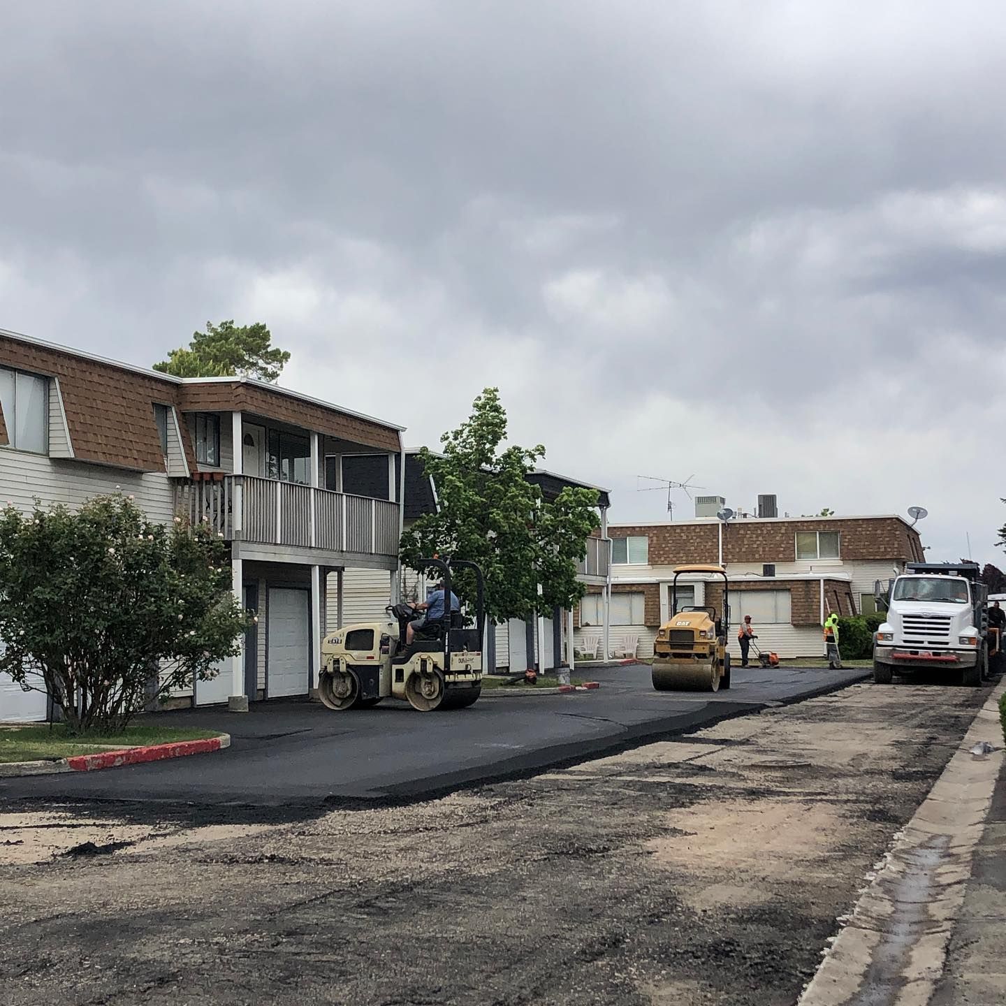 a road is being paved in front of a building