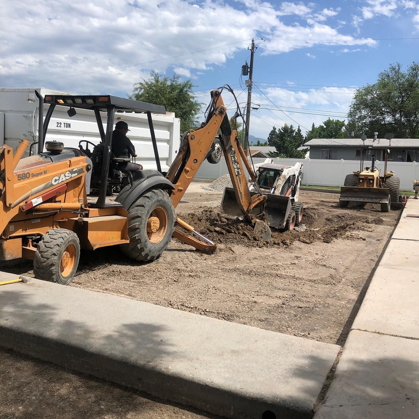 a man is driving a case backhoe in a dirt field