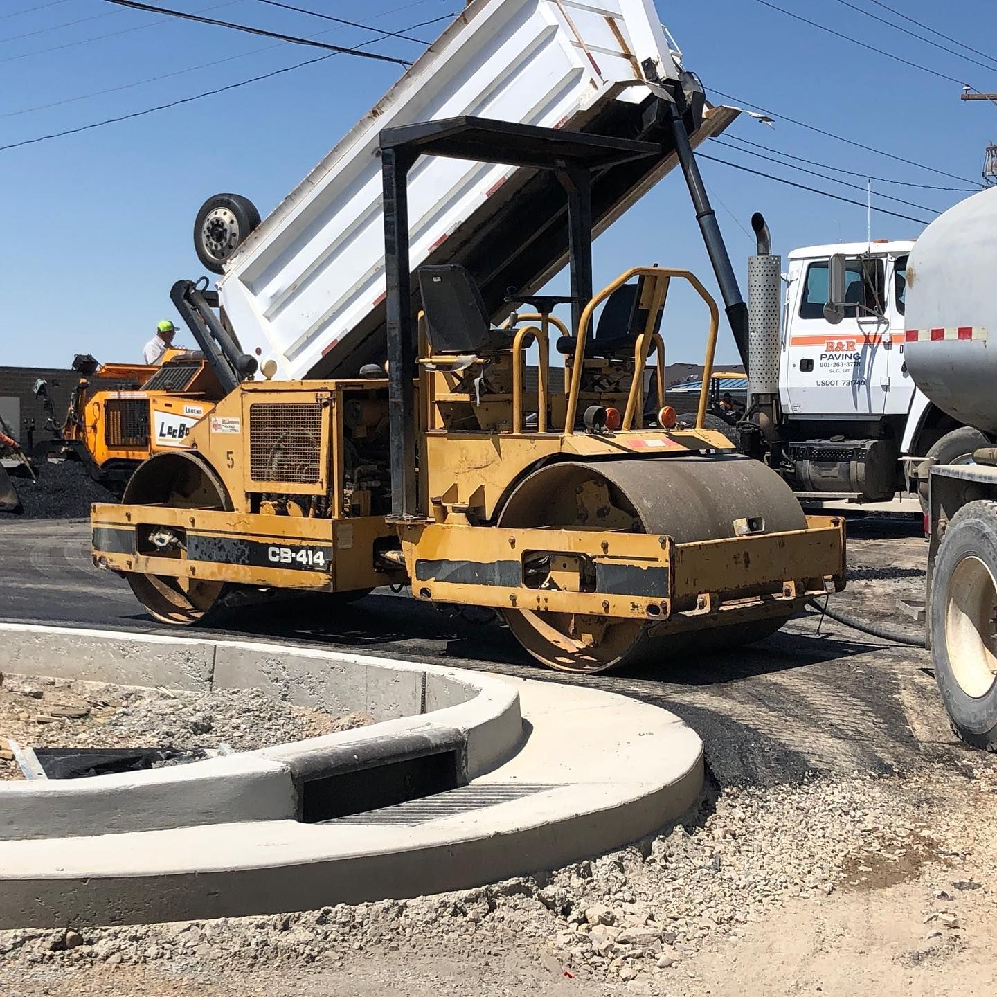 a dump truck is being dumped onto a construction site