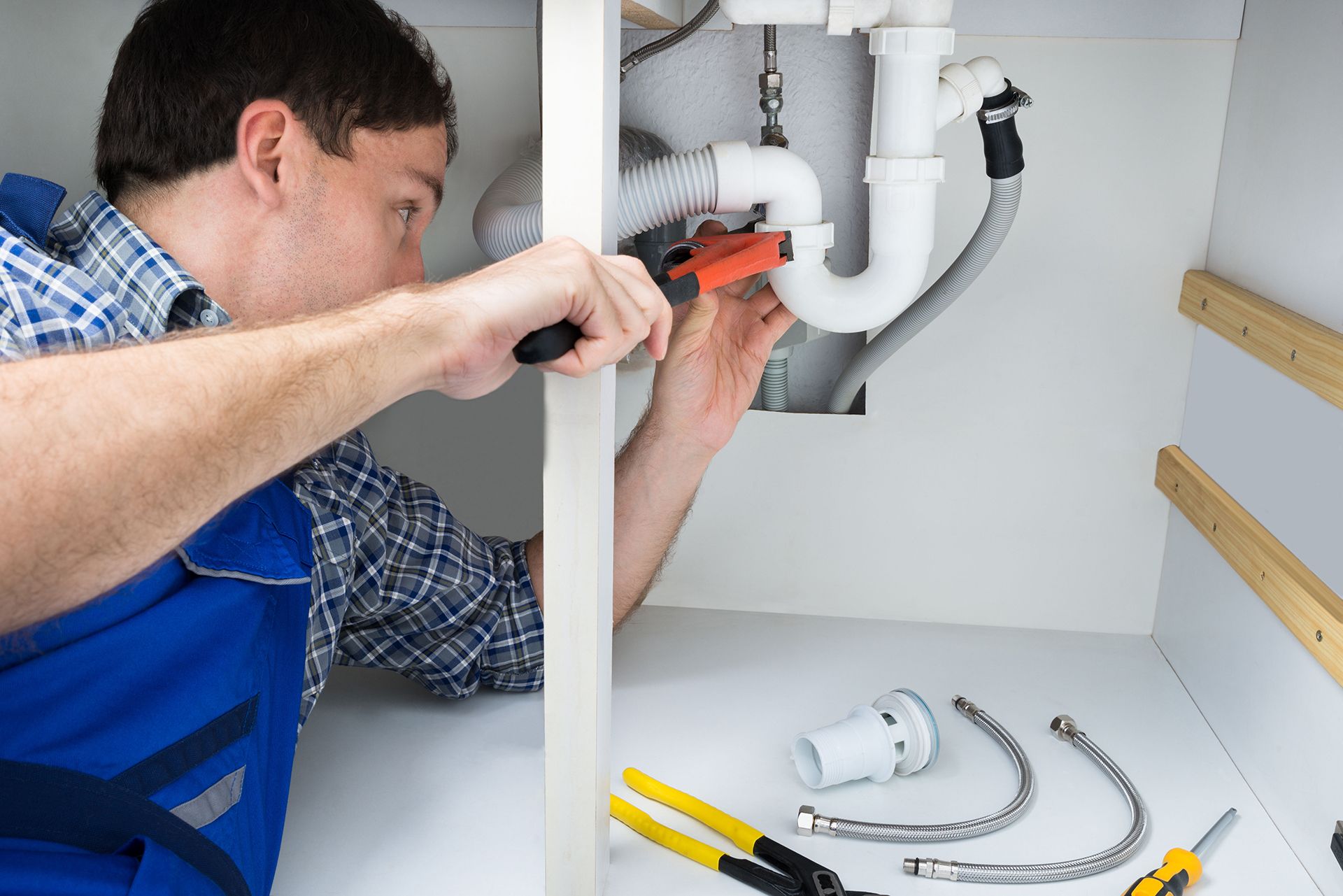 Male plumber fixing a sink