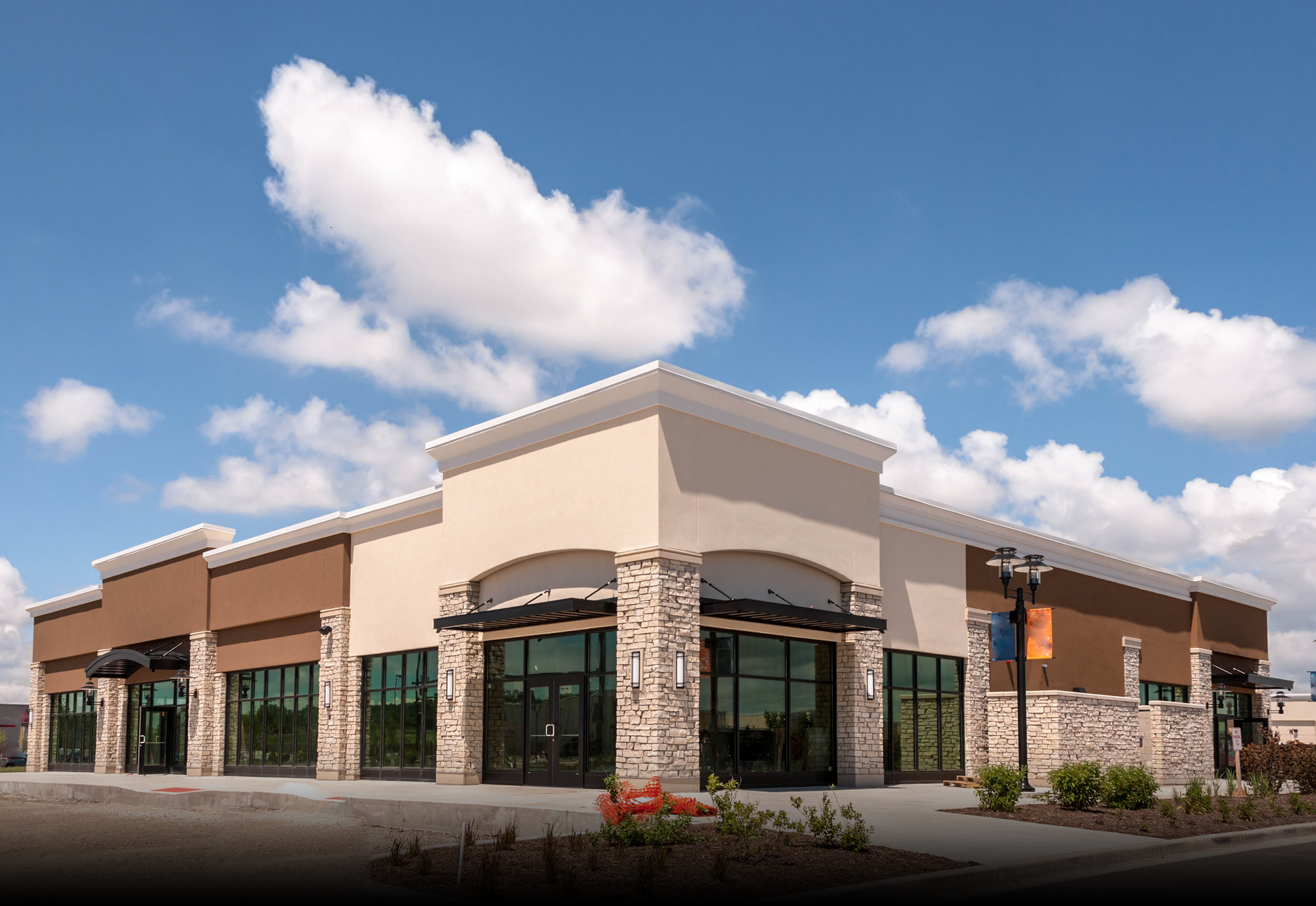 A large building with a blue sky and clouds behind it