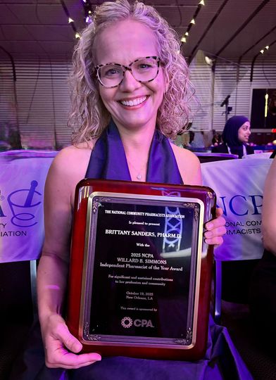 Brittany holding award by the NCPA