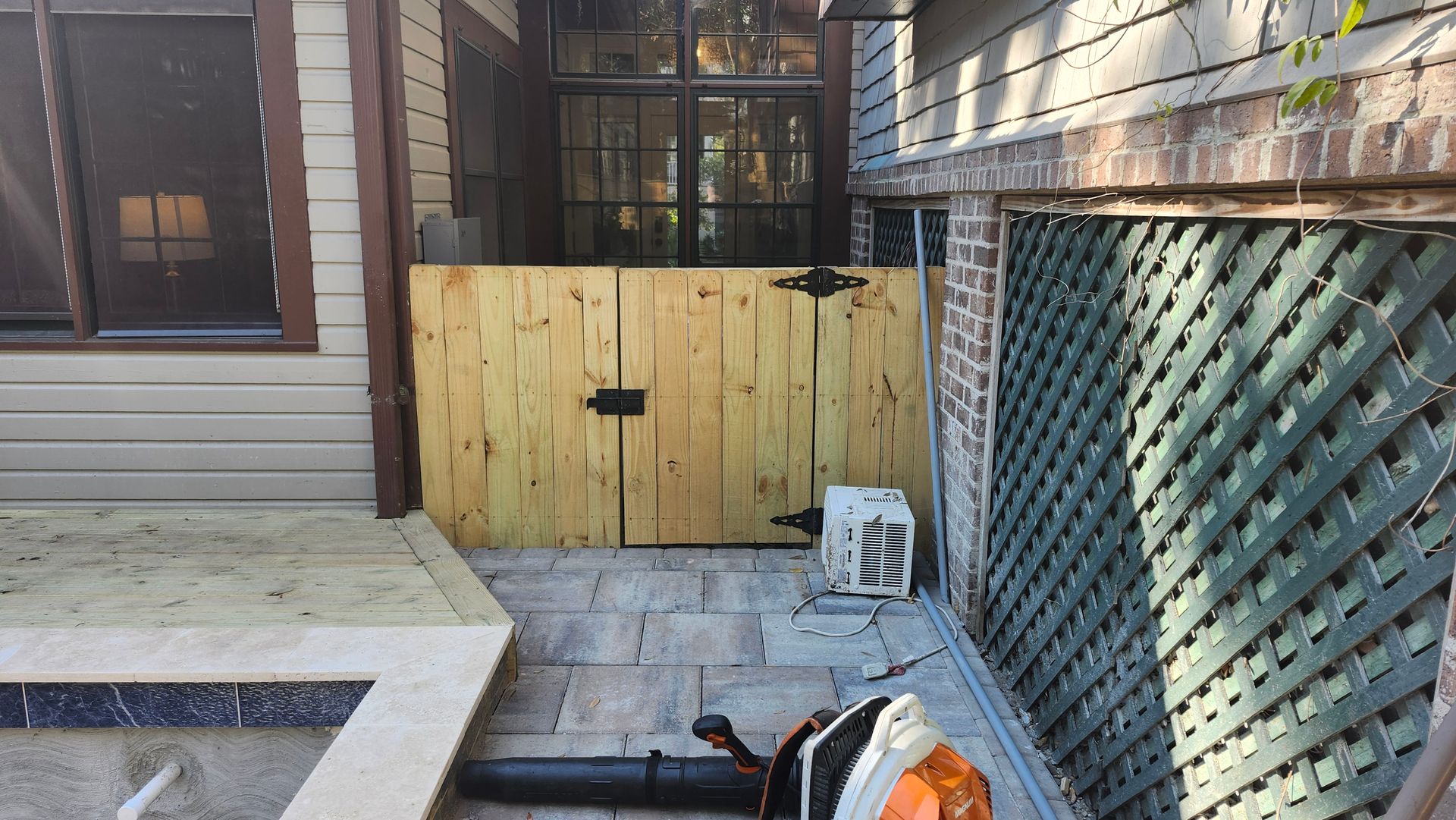 There is a swimming pool in the backyard of a house.