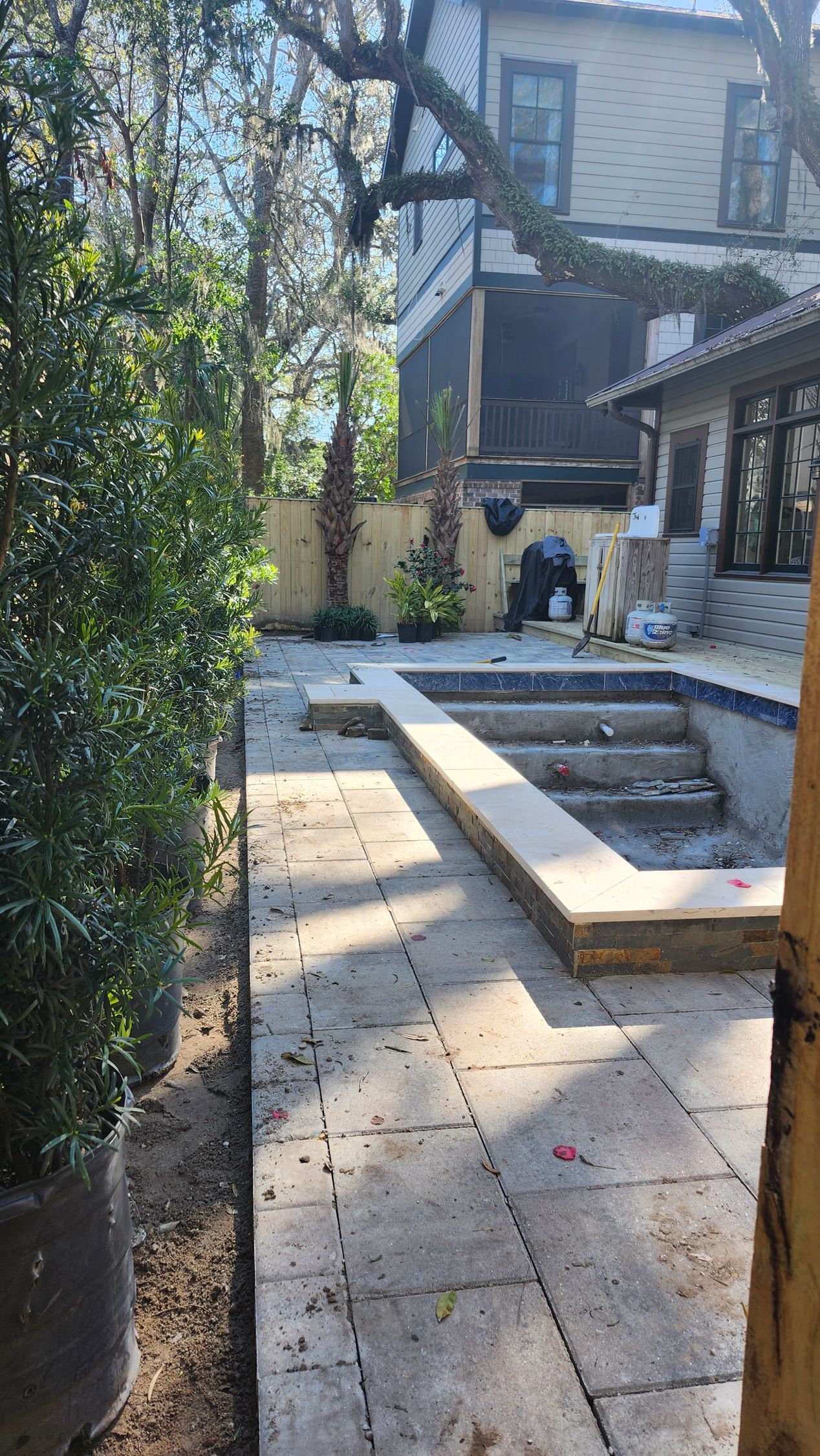 There is a swimming pool in the backyard of a house.