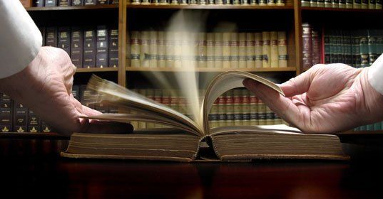 Hands opening the legal book