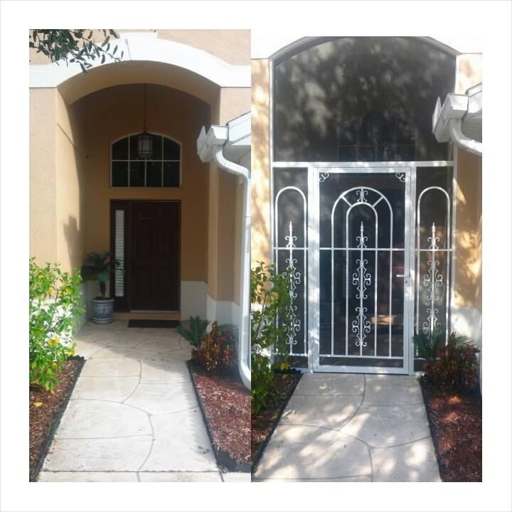 Entrance with doorway, arched transom, and security door in white over dark wood door.