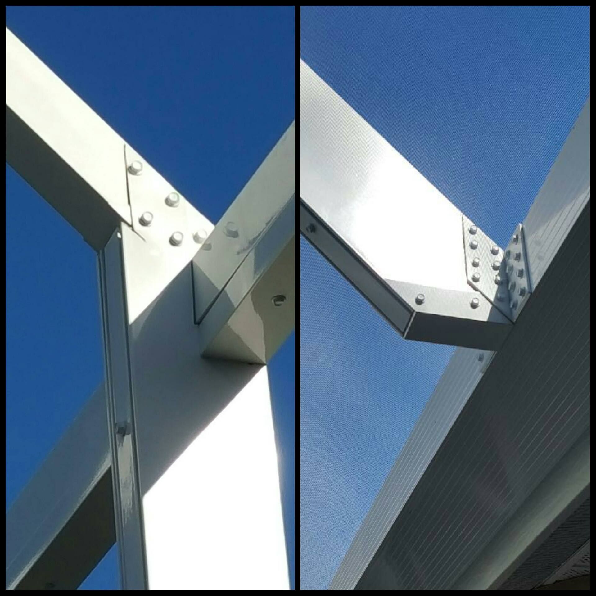 White steel beams joined with rivets against a blue sky.