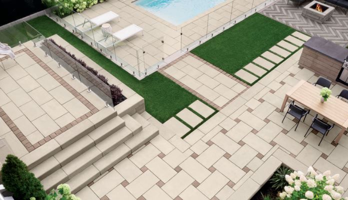 An aerial view of a patio with a table and chairs and a pool.