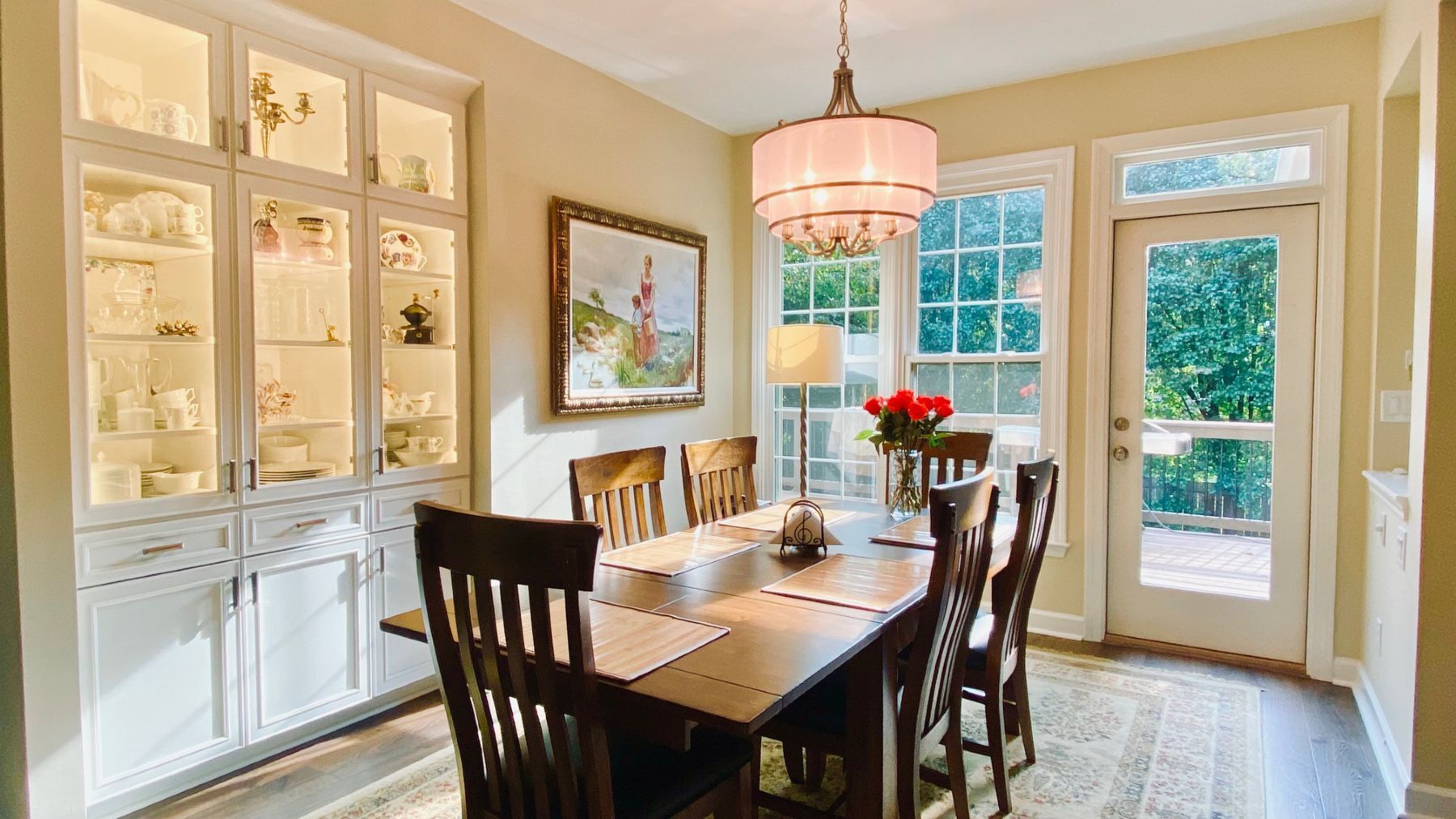 A dining room with a table and chairs and a chandelier.