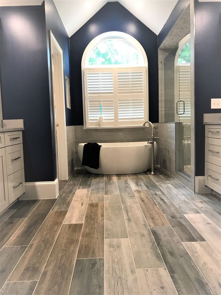 There is a bathtub in the middle of the bathroom.