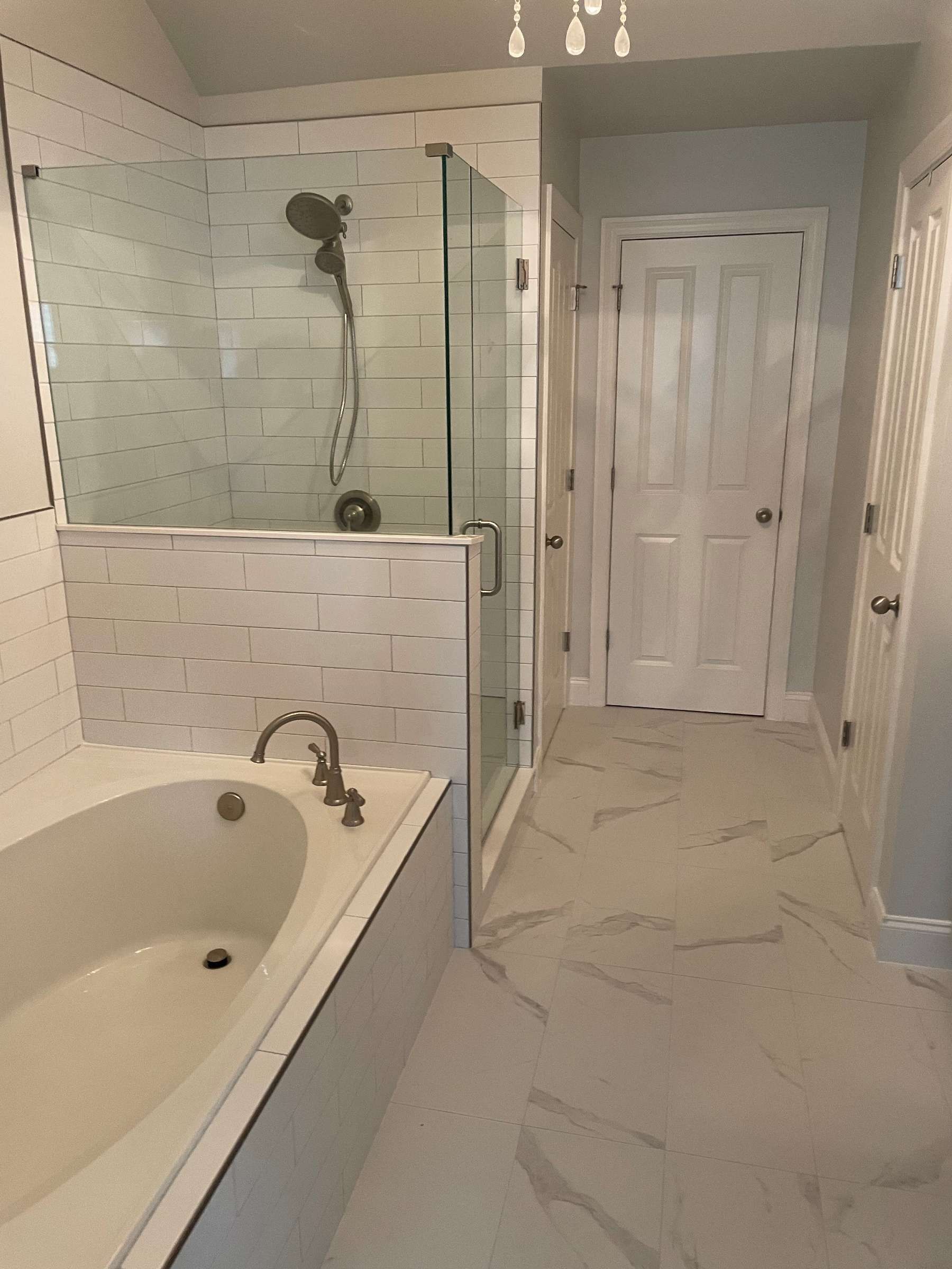 A bathroom with a bathtub and a walk in shower.