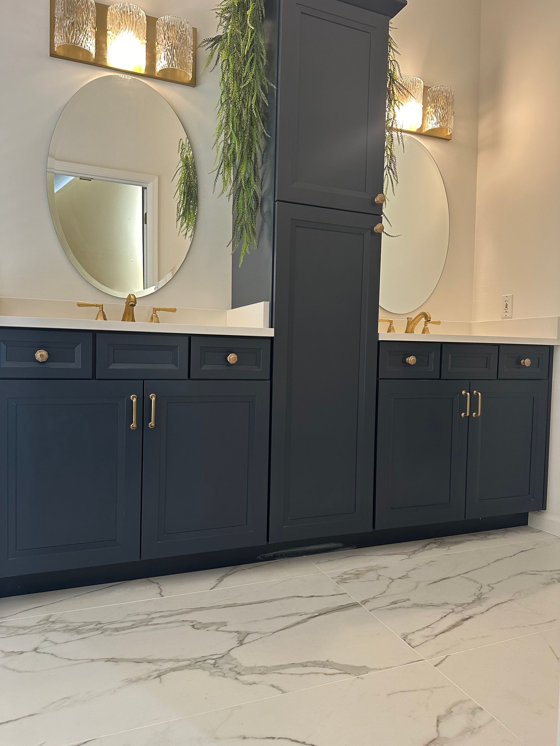 A bathroom with two sinks, two mirrors, and a marble floor.