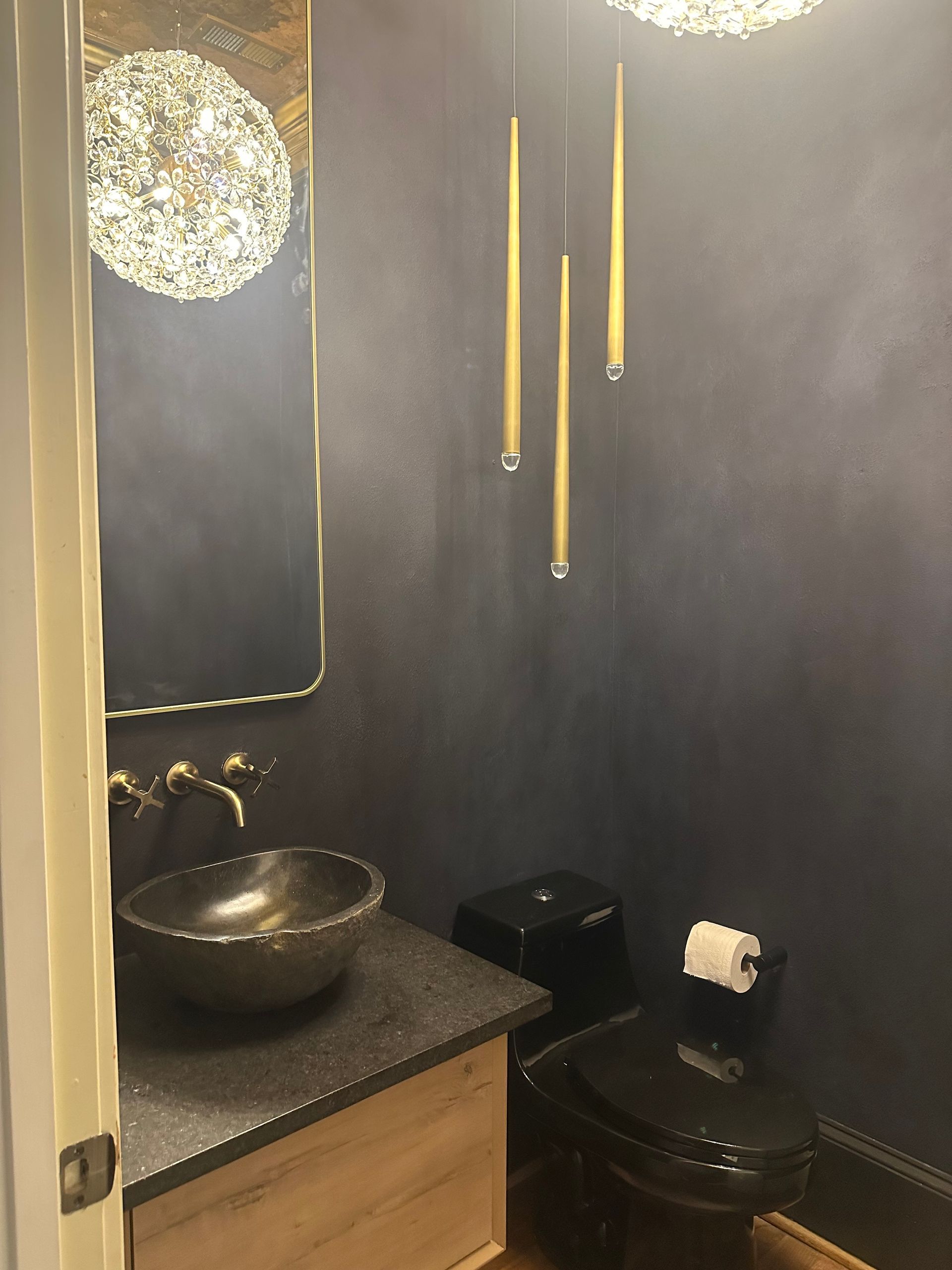 A bathroom with a sink, toilet, and mirror