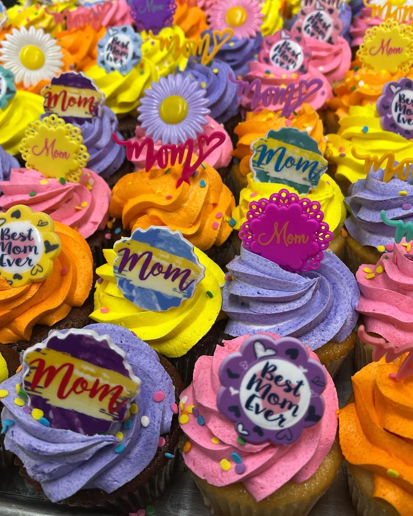 Colorful cupcakes with swirled frosting and