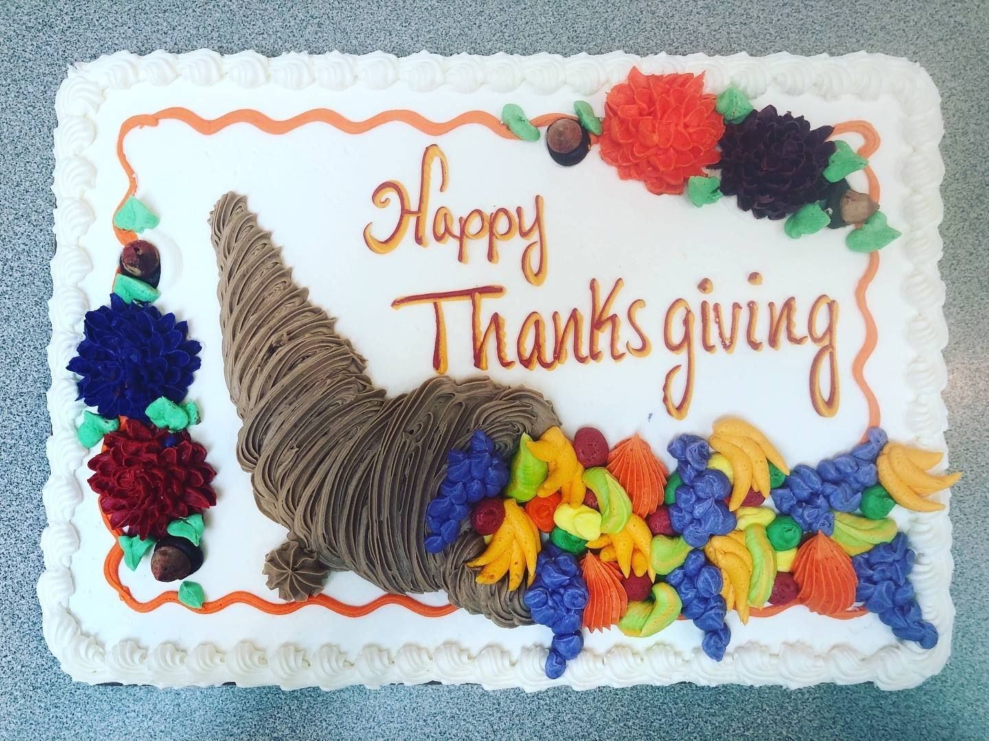 Thanksgiving cake with buttercream frosting and cornucopia design.